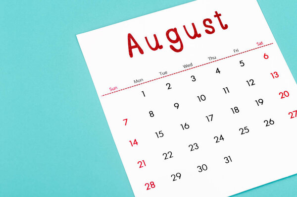 Close up August 2022 calendar sheet on light blue background.