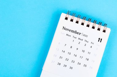 The mini November 2022 desk calendar on blue background.