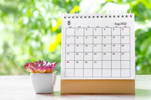 The August 2022 Calendar desk for organizer to plan and reminder on wooden table on nature background.