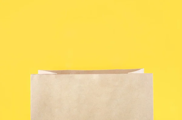 Open Brown Paper Shopping Bag Yellow Background — Foto de Stock