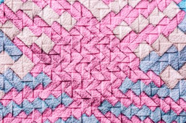 Arka plan olarak suni deri örgü dokusuna renkli soyut.