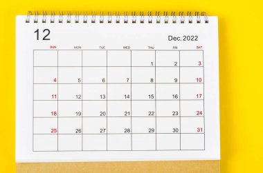 December 2022 Monthly desk calendar for 2022 year on yellow background.