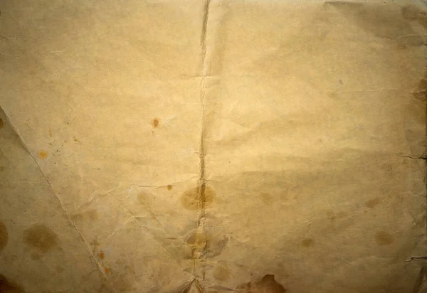 Texturen på gammalt gulnat papper med prickar och repor. Vintage text bakgrund. Ett pappersark av kartong från en antik skissbok. — Stockfoto