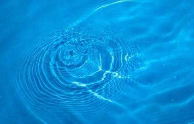 Round splashes in the clear blue water of the pool. Refreshing cool water in the Jacuzzi.