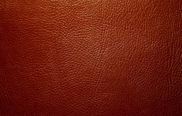 Photo of the texture of genuine leather in red.The leather background of the luxury brand. — 图库照片