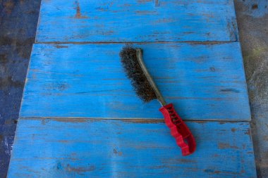 Metal brush for cleaning the wooden surface from old paint.