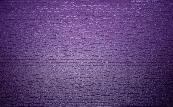 Otography of the texture of the yoga mat purple color. Soft background of a sports mat. — Stockfoto