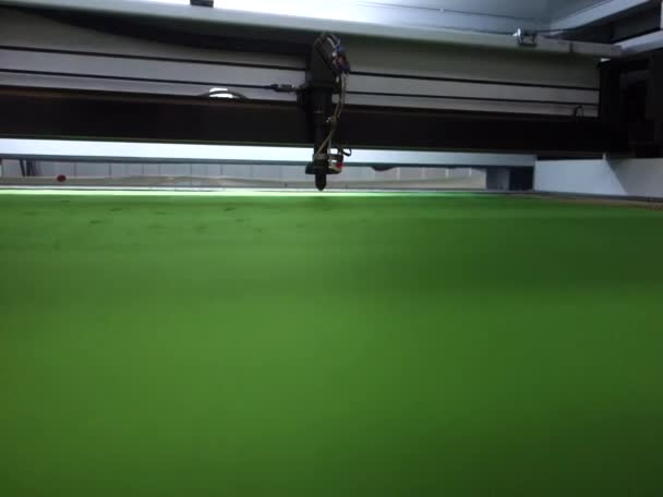 Μηχανή λέιζερ σε παραγωγή, κόβει το πράσινο ύφασμα τσόχας σε μέρη. Προετοιμασία εξαρτημάτων. Παραγωγή προϊόντων ρομποτικού εξοπλισμού — Αρχείο Βίντεο