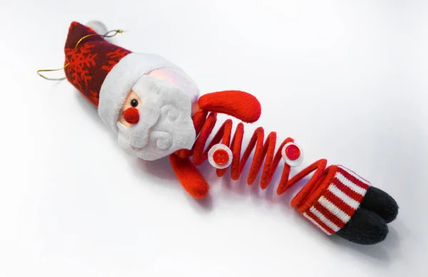 Red Santa Claus on a spring. Christmas toy on white isolate. — стоковое фото