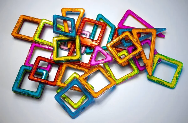 Details of a magnetic constructor made of plastic of different colors on a white isolate. An interactive game for children. — Stock Photo, Image