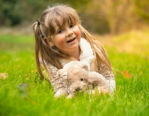 Cute little girl cuddling her teddy bear Royalty Free Stock Images