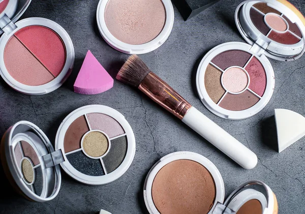 Various makeup up products on a grey background — ストック写真