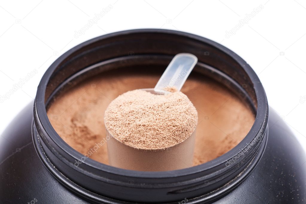 Scoop of chocolate whey isolate protein in a black plastic conta