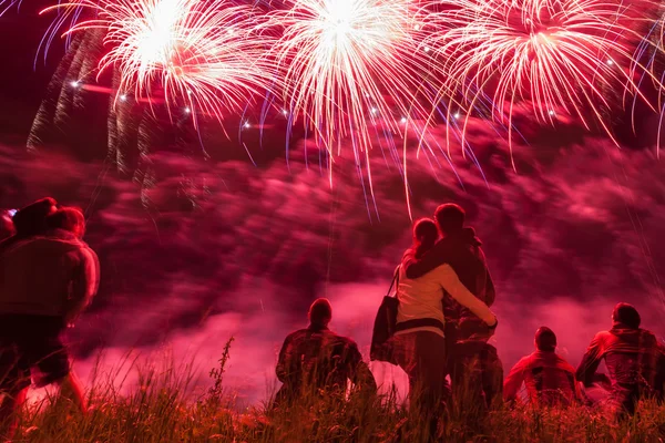 Big fireworks with young romantic couple in love in front, holdi — Stock Photo, Image