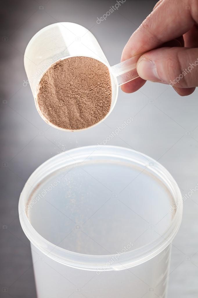 Plastic scoop of chocolate whey isolate protein foto de Stock