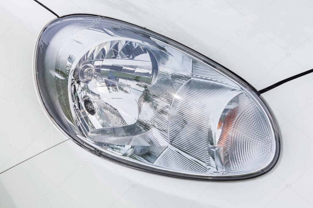 Closeup of the headlights of a white car