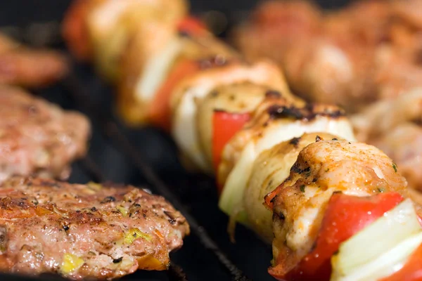 Meat and skewers on the grill — Stock Photo, Image