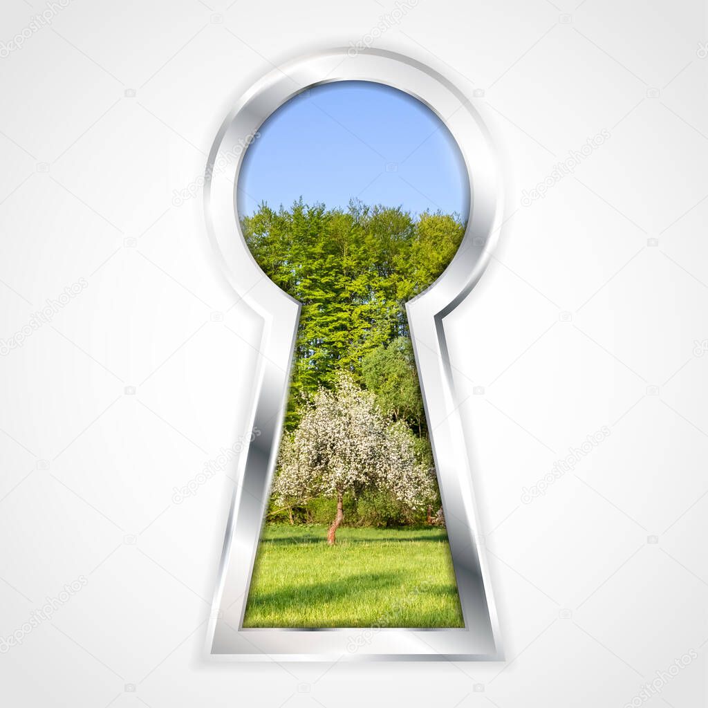 View of spring landscape with flowering tree and blue sky in abstract silver keyhole