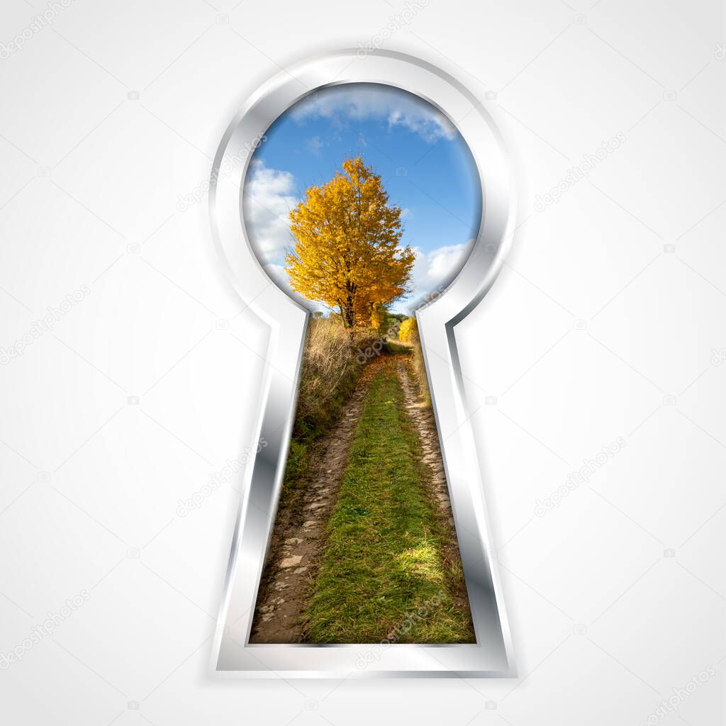 View of autumn landscape with dirt road, colorful fall tree and blue sky in abstract silver keyhole