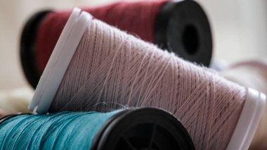 Colored sewing thread reels on fabric