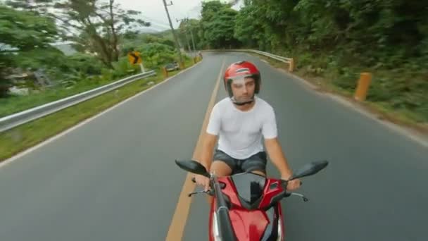 Турист в шлеме катается на велосипеде по междугородней дороге в Пхукете, Таиланд Стоковое Видео