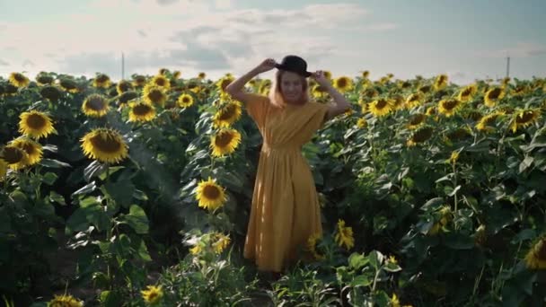 Wanita berambut merah di ladang bunga matahari di pemotretan mengambil gambar melalui telepon — Stok Video