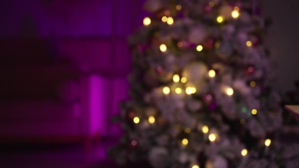 Концепция кануна Нового года. подарочные коробки на столе против украшенной елки — стоковое видео
