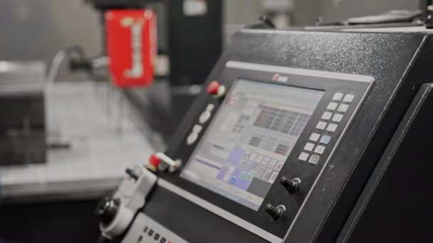 The operator sets program for computer numerical control, presses touch screen — Stockvideo