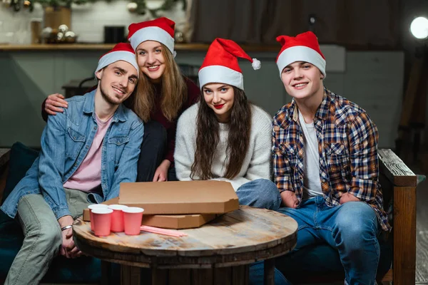 Man with disability with amputated hands with friends in red Santa Claus hats Royalty Free Stock Images