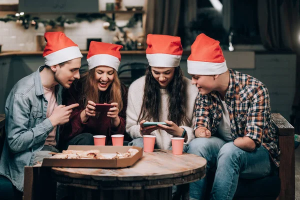 Girls gamble on phone games, guys cheer them up. Youth New Years party Stock Image