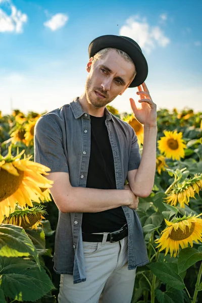 Young guy with, pierced in a sunflower field Royalty Free Stock Images