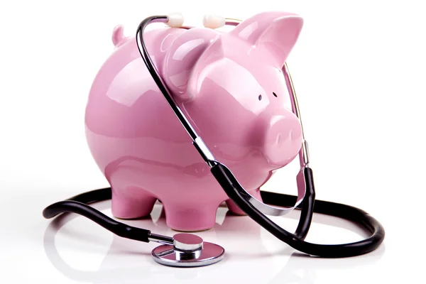 A piggy bank and a stethoscope Stock Image