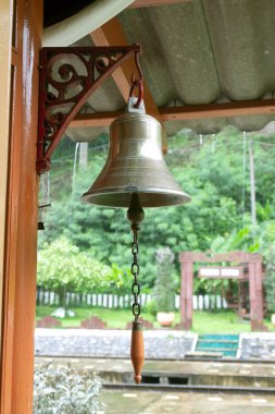 Goldden bell at train station.