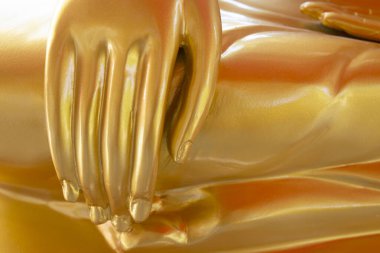 Hands of Golden Buddha statue in the buddhist temple