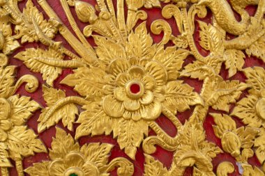 Thai traditional patterns and golden wall flower stucco in the temple of thailand