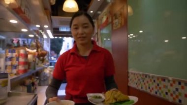 HONG KONG - 21 Ocak 2020: Hong Kong, Çin 'deki et pazarında kırmızı tişörtlü bir kadın.