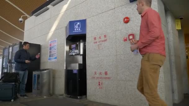 HONG KONG - 20 JANUARI 2020: Passagerare nära toalett- och varuautomater i Hongkongs flygplatsterminal — Stockvideo