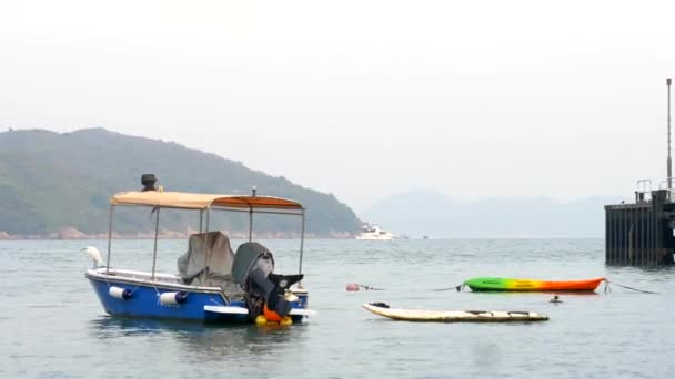 Ein kleines Motorboot schwimmt tagsüber auf dem Wasser in Hongkong — Stockvideo