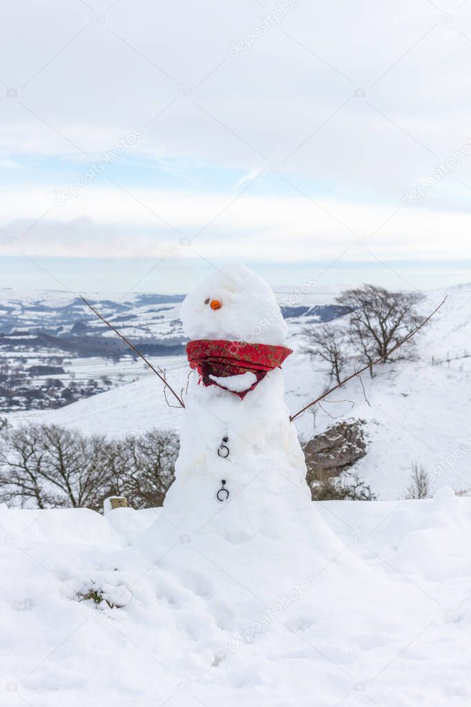Winter view of snowman, Peak District, Derbyshire, UK.