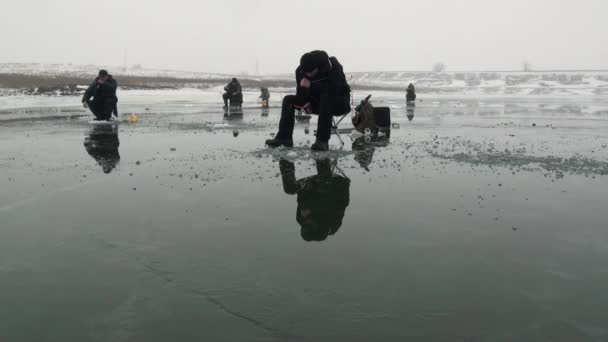 Pessoas pescadores vão sentar-se na competição no gelo no inverno — Vídeo de Stock