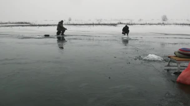 La gente pescadores ir sentarse en la competencia en el hielo en invierno — Vídeos de Stock