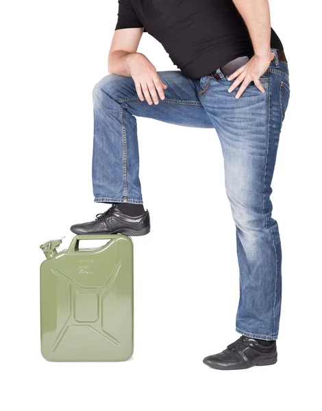 Man with a foot on jerrycan — Stock Photo, Image