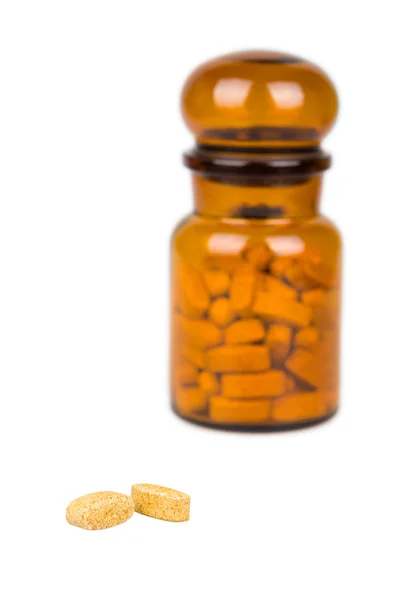 Two pills and apothecary jar — Stock Photo, Image