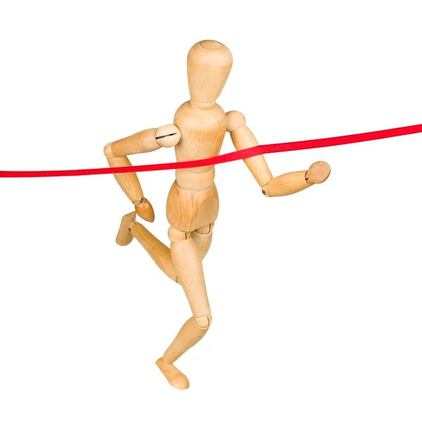 Wooden mannequin running through finishing line — Stock Photo, Image