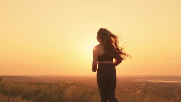 Girl jogging at sunset sky, active lifestyle rays sun, cardio training nature, running man bright light, monitor health and body shape, activate the body metabolism with physical exercise exercises — Stock Video