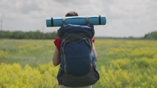 Genç milenyum kızı sırt çantası ve turist halısıyla seyahat eder, mutlu bir gün, mutlu tatil konsepti, turist yolunda doğa tatili, tatilde macera arayışı, gezgin konsepti — Stok video