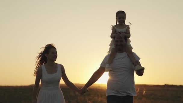Father mother and child run at sunset in sky, silhouette of happy family, little kid sits on dad shoulders, family trip, fun life parents and daughter, play outdoor nature superhero, weekend together — Stock Video