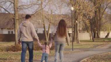 Annesi ve babasıyla birlikte eve dönen çocuk mutlu bir aile, uçmayı hayal eden küçük bir çocuk, anne, baba ve bebek parkta yürüyor, birlikte seyahat ediyor, kızıyla aile günü, neşe içinde velayet günü.