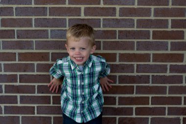 bir tuğla duvar tarafından genç çocuk.