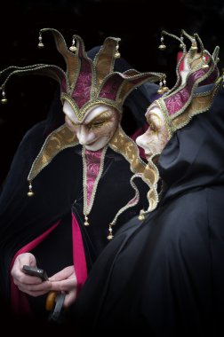 Harlequin ve Venedik Karnavalı üstünde hareket eden telefon